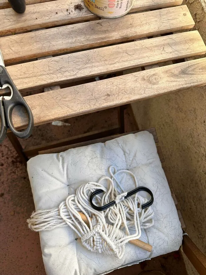 Wooden balcony chair covered in pet hair, showing a messy situation caused by infuriating neighbors.