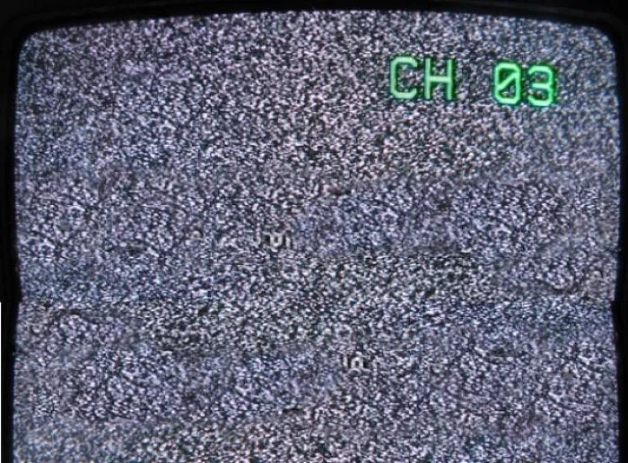 Old TV screen showing static with green channel 3 indicator in corner
