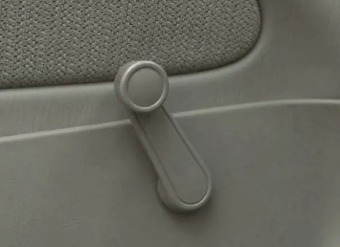 Vintage car manual window crank handle closeup