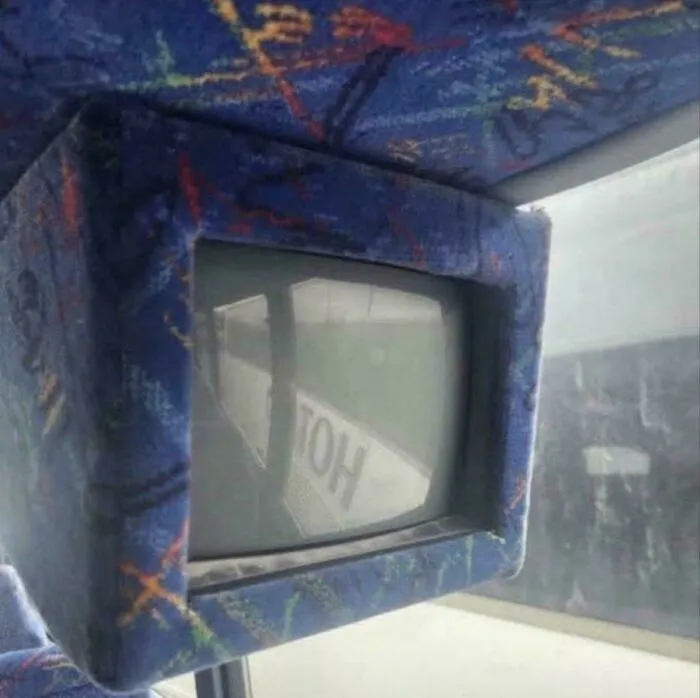 Nostalgic photo of old CRT TV inside patterned bus seat