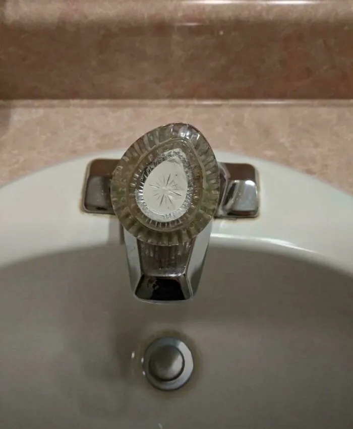 Nostalgic photo of vintage glass faucet handle on bathroom sink