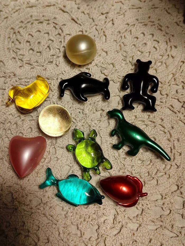 Collection of colorful classic plastic toy charms arranged on a beige fabric