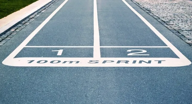 A running track starting line showing distance, symbolizing feet in a mile.