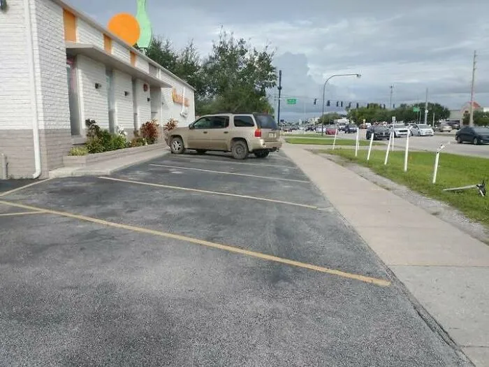 Parking fail with vehicle parked on a curb blocking sidewalk access