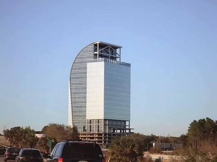 Incomplete building construction with mismatched sections and exposed framework