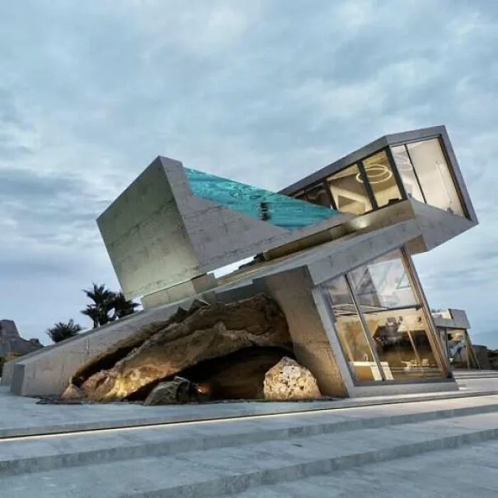 Modern house with tilted concrete structure and pool looking like a construction fail