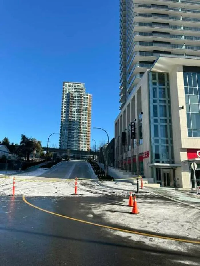 Blocked urban street with construction cones amid icy road causing safety fail