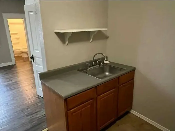 Small kitchen sink cabinet with limited counter space and odd layout