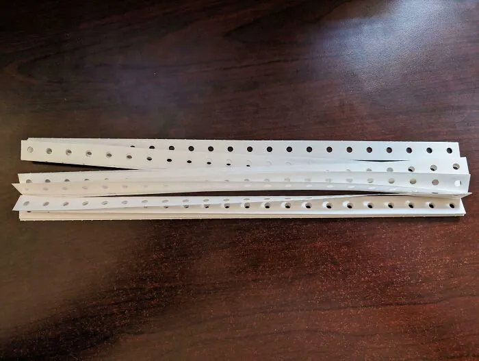 Old nostalgic computer punch cards with holes on a wooden table