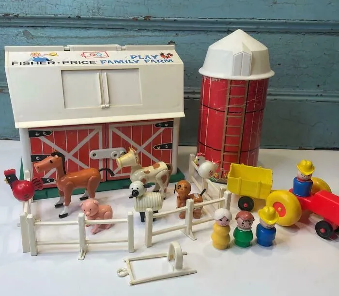 Vintage Fisher-Price Family Farm toy set with barn, silo, animals, and tractor