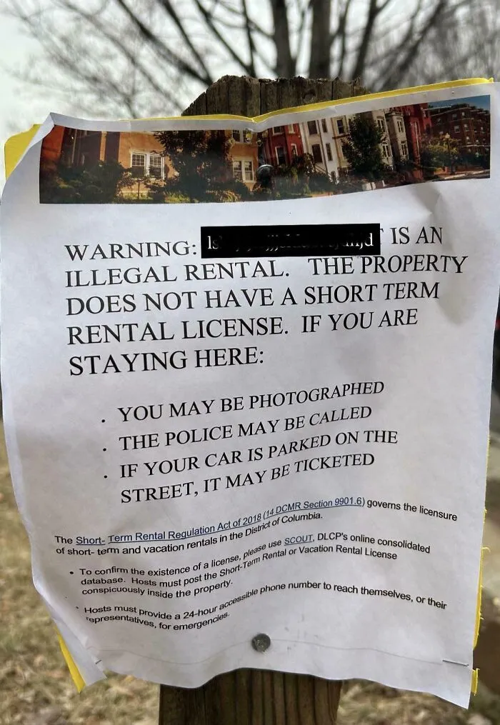 A posted warning notice on a pole about illegal rentals posted by infuriating neighbors in a residential area.