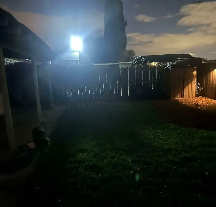 Extremely bright floodlight shining into a yard at night, example of infuriating neighbors.
