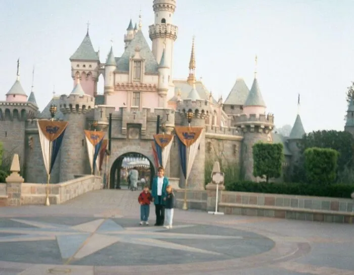 Family standing in front of Sleeping Beauty Castle in 2001.