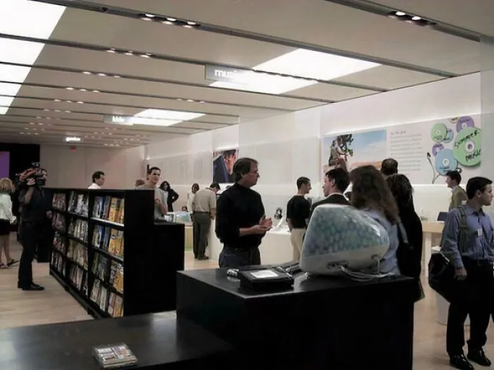 Steve Jobs inside an early Apple Store opening in 2001 showcasing original iMac computers