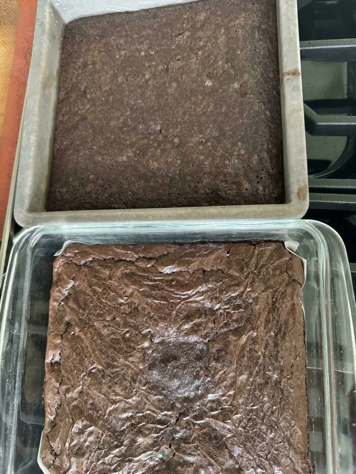 Two square baking pans side-by-side comparing a dark cakey brownie with a shiny crinkle-top brownie, demonstrating r/bakingfail.