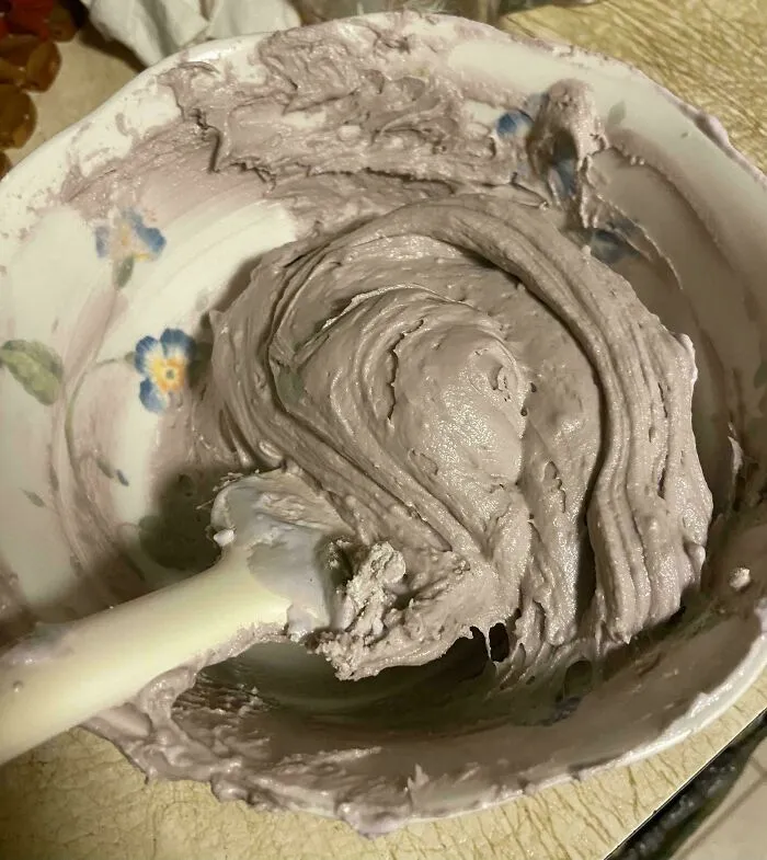 Thick grey frostings swirled in a bowl as a baking fail.