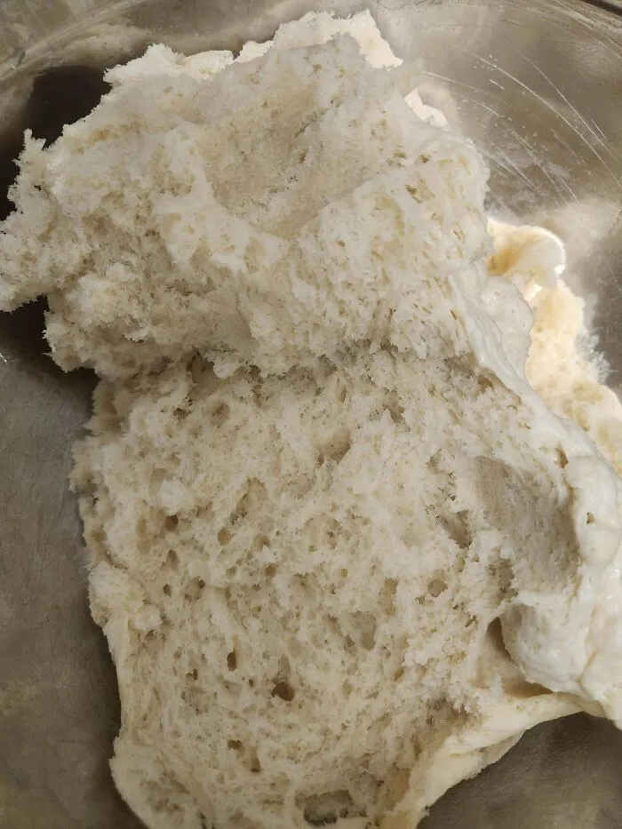 Close up of overmixed lumpy dough in a bowl illustrating a common baking fail.