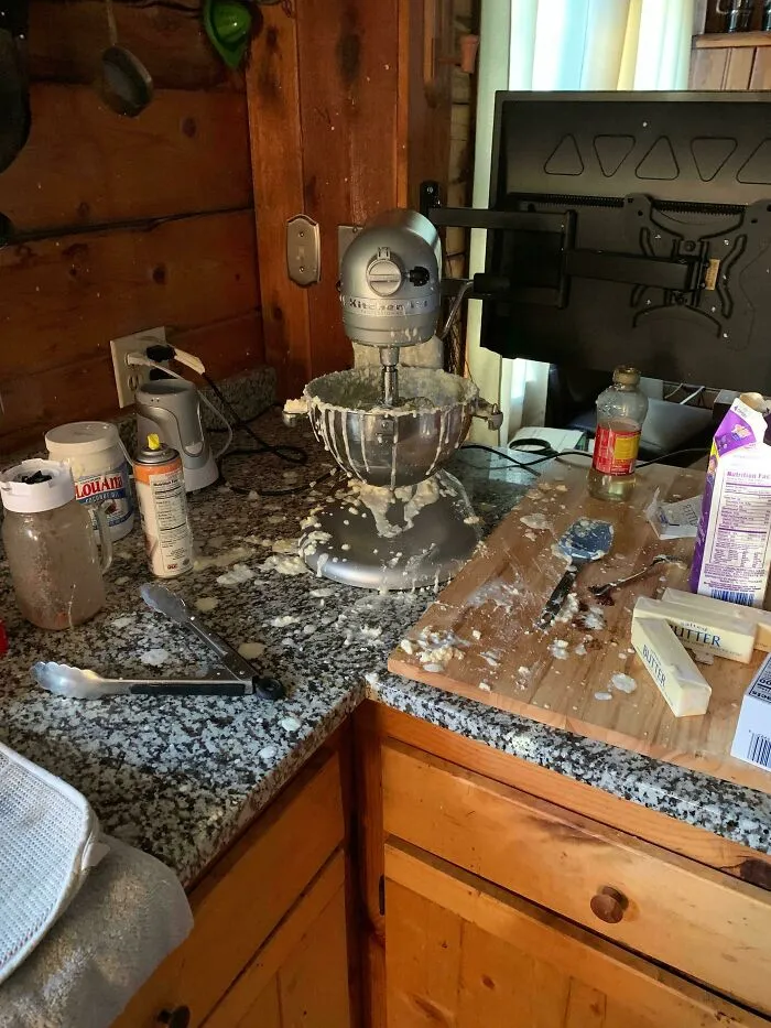 Kitchen counter messy with batter splatters around a stand mixer from a baking fail.