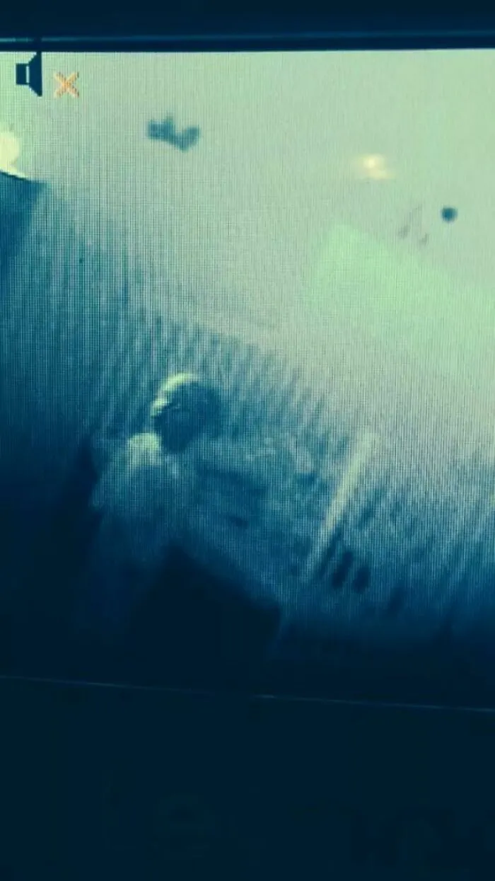 A blurry, unsettling security camera view of a person at night, captured in cursed images.