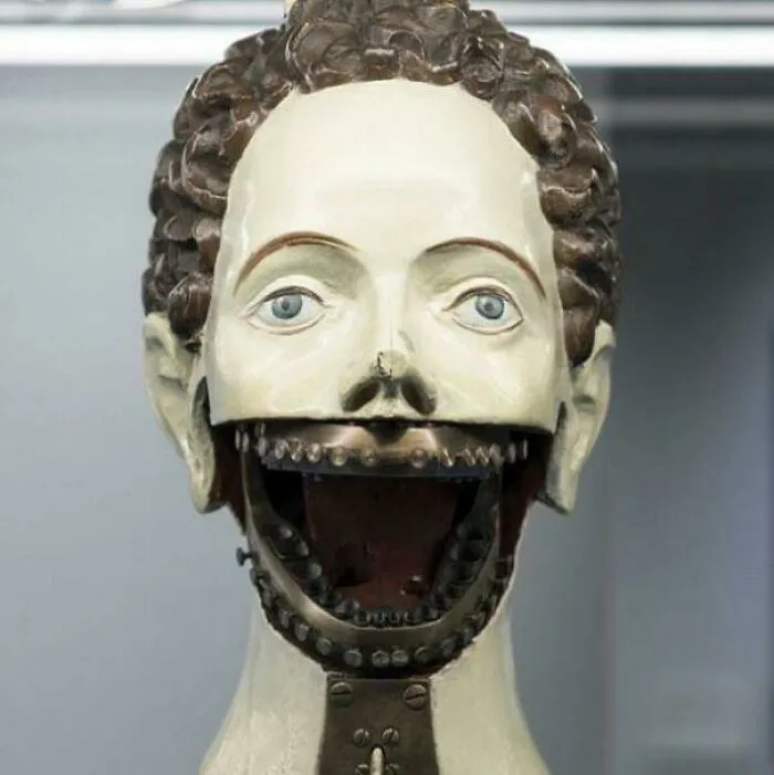 Cursed images featuring a creepy vintage medical mannequin head with a wide open mechanical jaw