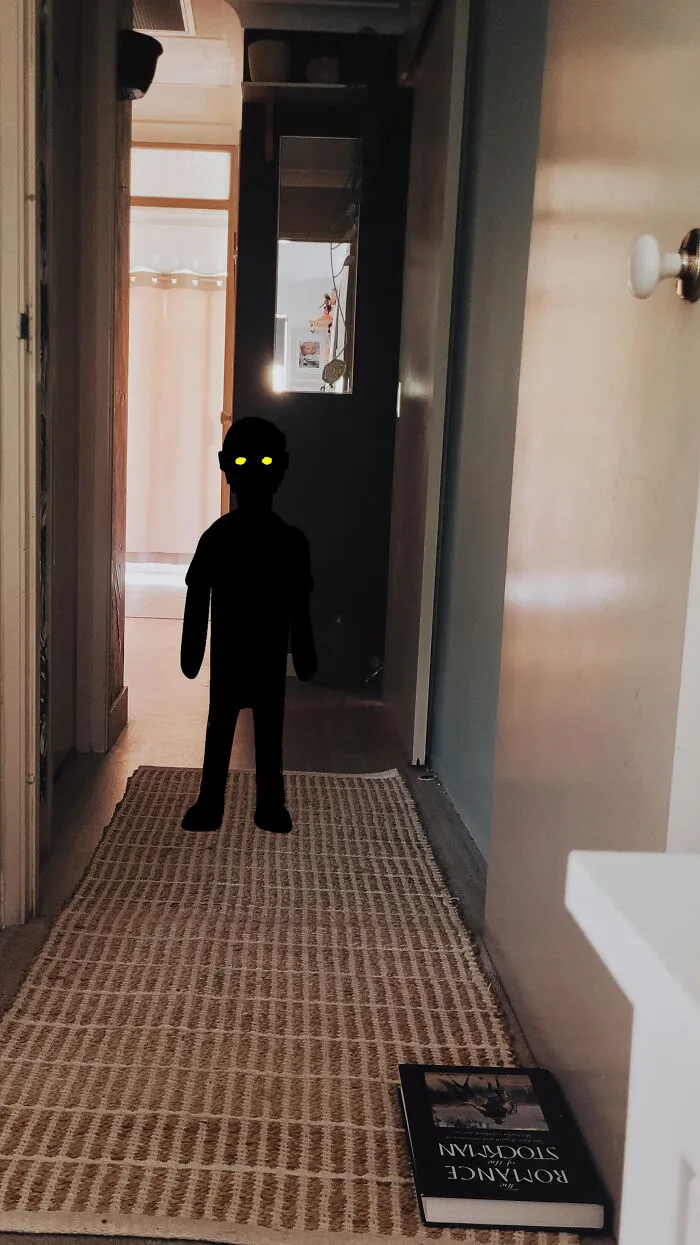 Creepy photos showing a shadowy dark figure with glowing yellow eyes standing in a narrow hallway.