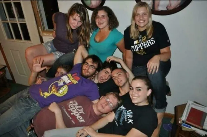 A group pose turns into creepy photos as an extra face peeks from behind a door window