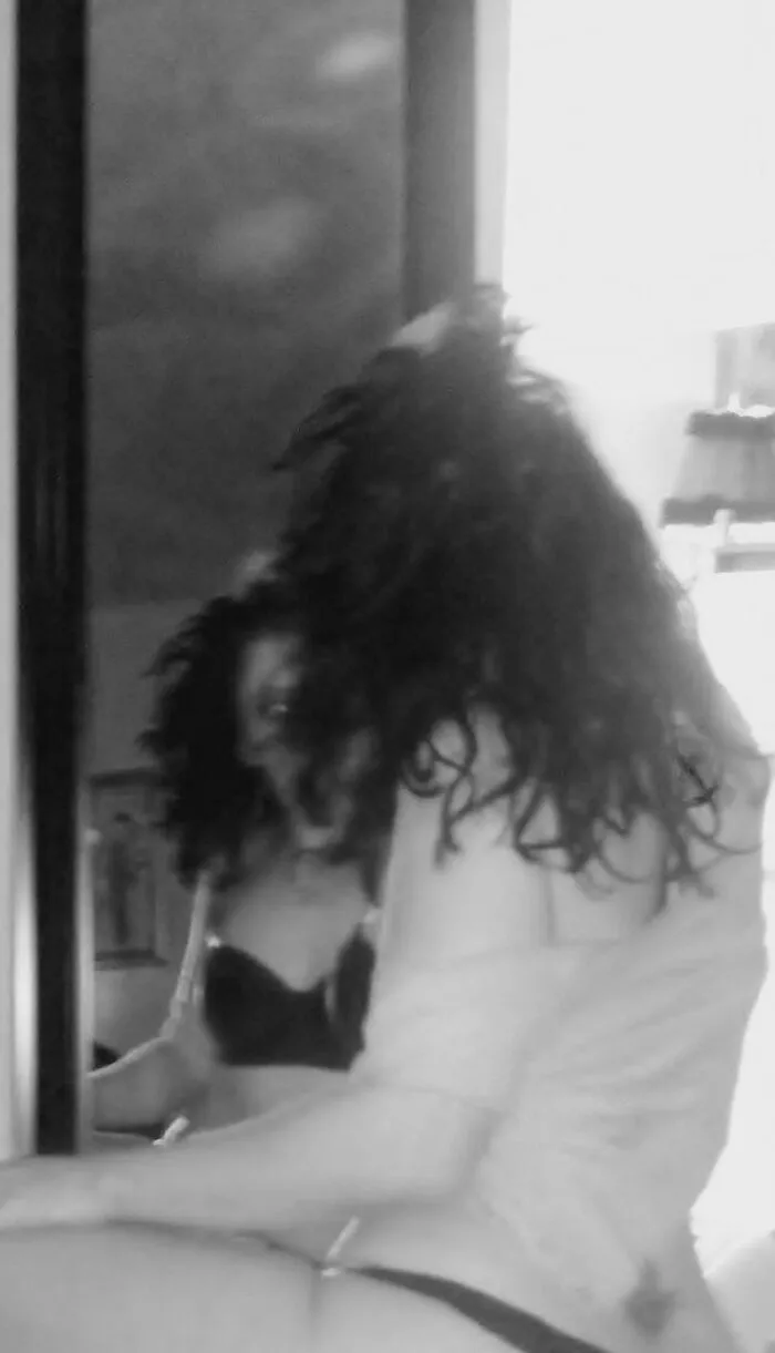 Blurry mirror reflection showing dark distorted silhouette in creepy photos.