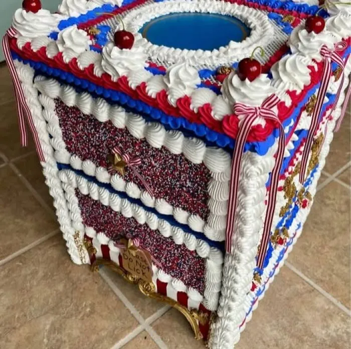 A creative yet bizarre craft project of small drawers decorated to look like a cake with icing and cherries.