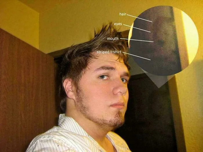 A man taking a selfie with a zoomed-in dark figure behind him, highlighting creepy photos with spooky details.