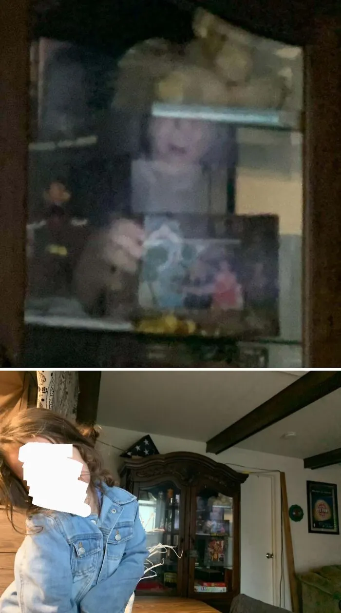 A reflection in a display cabinet showing an eerie face, fitting for creepy photos.