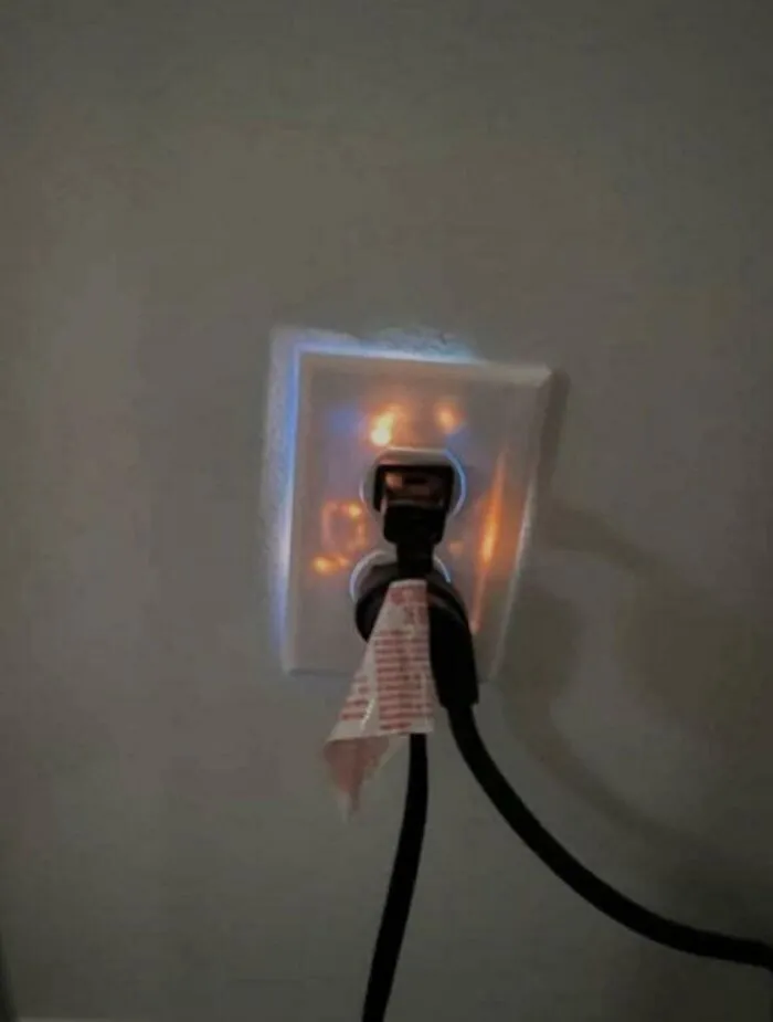 An electrical outlet dangerously glowing from inside in a collection of cursed images.