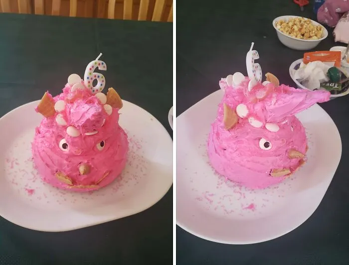 A funny bakingfail of a pink piggy cake decorated with candies and a birthday candle on a white plate.