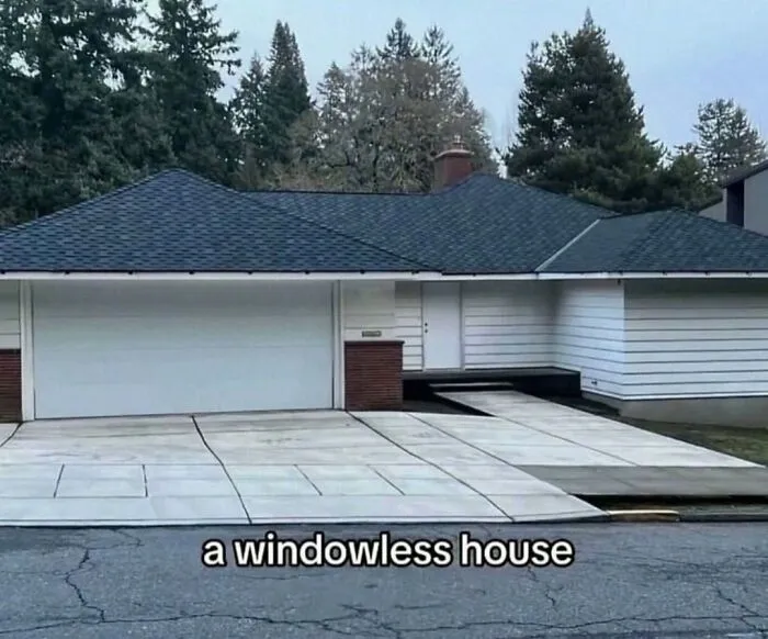 A suburban house with no windows, presenting cursed images of eerie architecture.