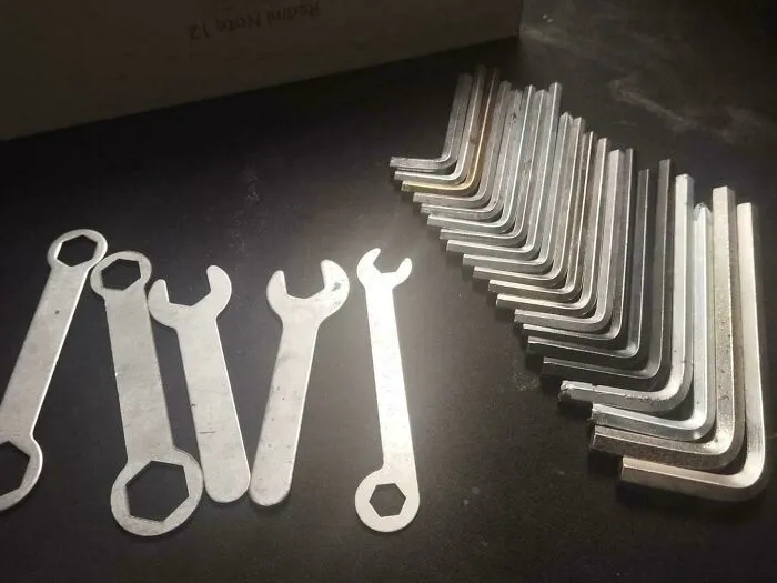 A collection of flat wrenches and Allen keys neatly arranged on a table for home DIY projects by a dad.