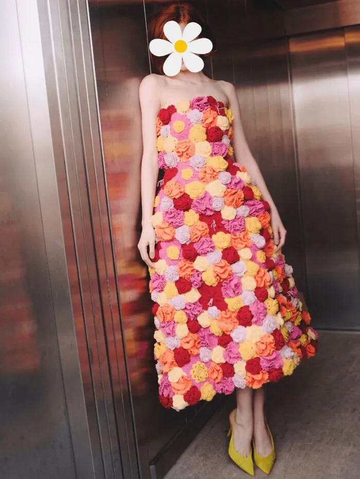 Woman wearing a floral crochet dress with multicolored flowers