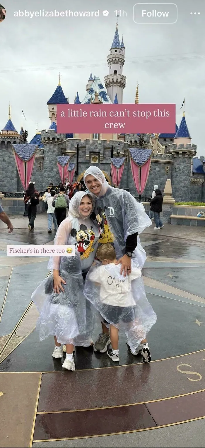 Family in Mickey Mouse ponchos at Disneyland on rainy day