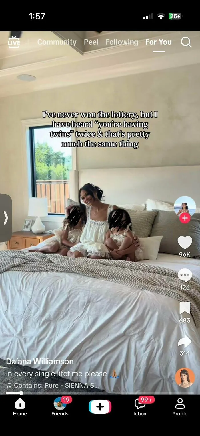 Mom with her two kids in bed discussing having twins