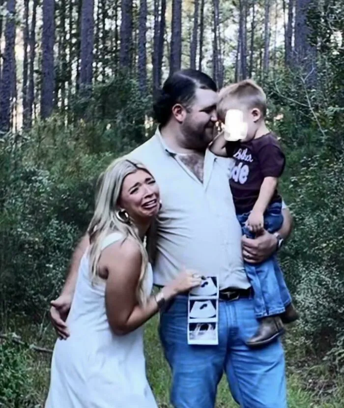 Family moment with couple and child in forest setting