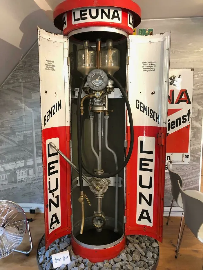Antique Leuna fuel pump with open doors showing internal mechanics