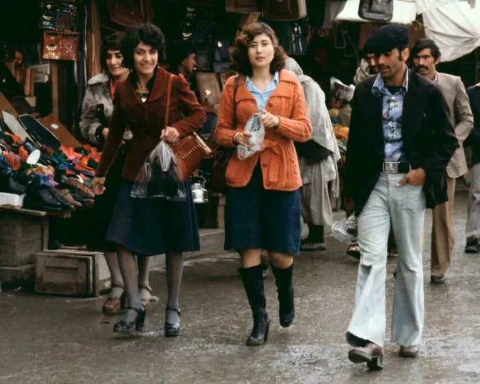 Rare historical photo of people walking and shopping at an outdoor market in the 1970s