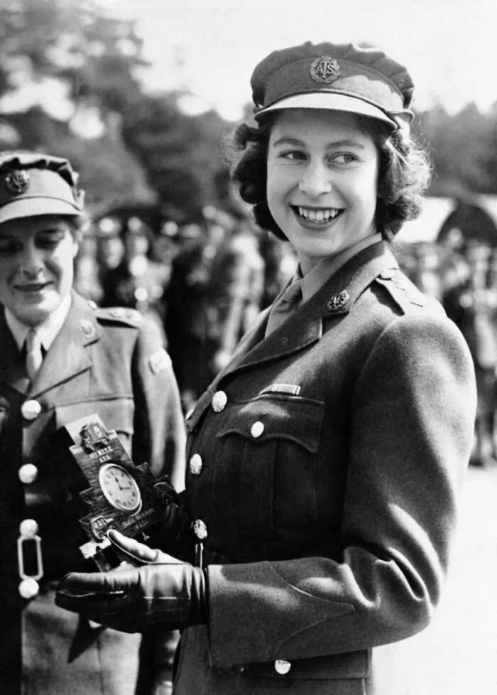 Historic photo of a young woman in military uniform smiling during World War II