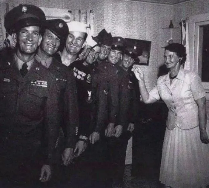 Vintage rare historical photo showing soldiers smiling with a woman indoors