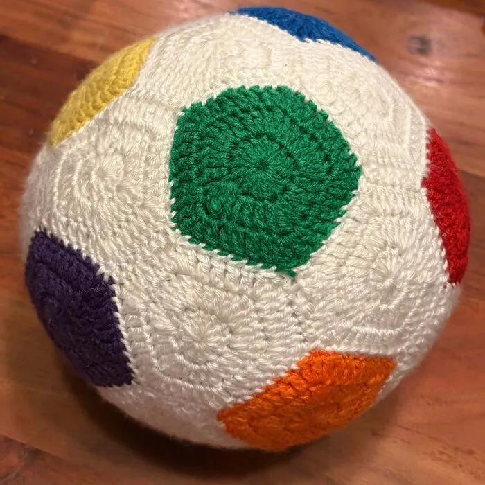Crochet ball covered in colorful geometric patch patterns