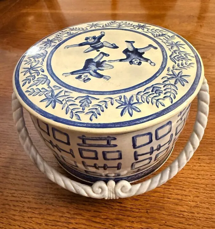Blue and white vintage ceramic biscuit jar with dog motifs