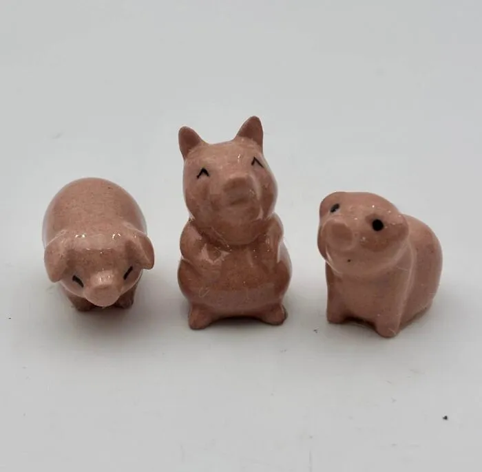 Three ceramic pig figurines thrift store finds in pink glaze