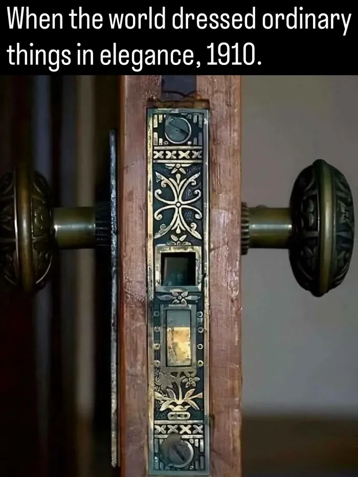 Close-up of an ornate 1910 brass door lock mechanism, highlighting detailed facts about history.