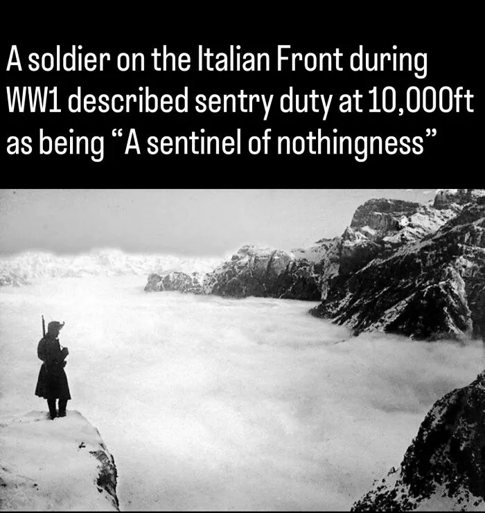 A WW1 soldier stands sentry on a snowy mountain peak on the Italian Front in fascinating photos about history.