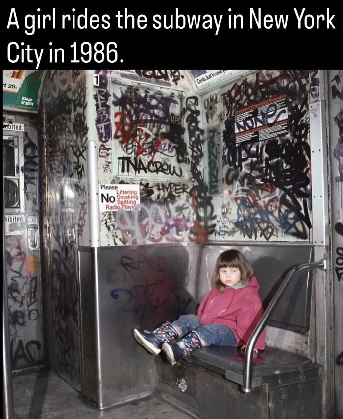 A young girl sits alone in a graffiti-covered NYC subway car in 1986, showing fascinating photos about history.