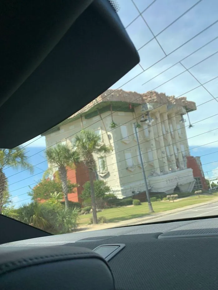 Upside down building seen through car window showing architectural glitch