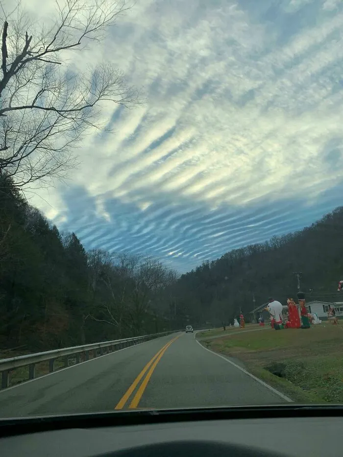 Road under sky with unusual ripple clouds glitch in the matrix